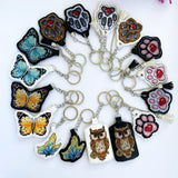 White dog paw on white Embroidery Kit: DIY Keychain, Leatherette Base